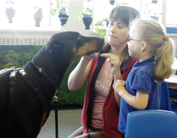 Girl and woman with a Doberman.